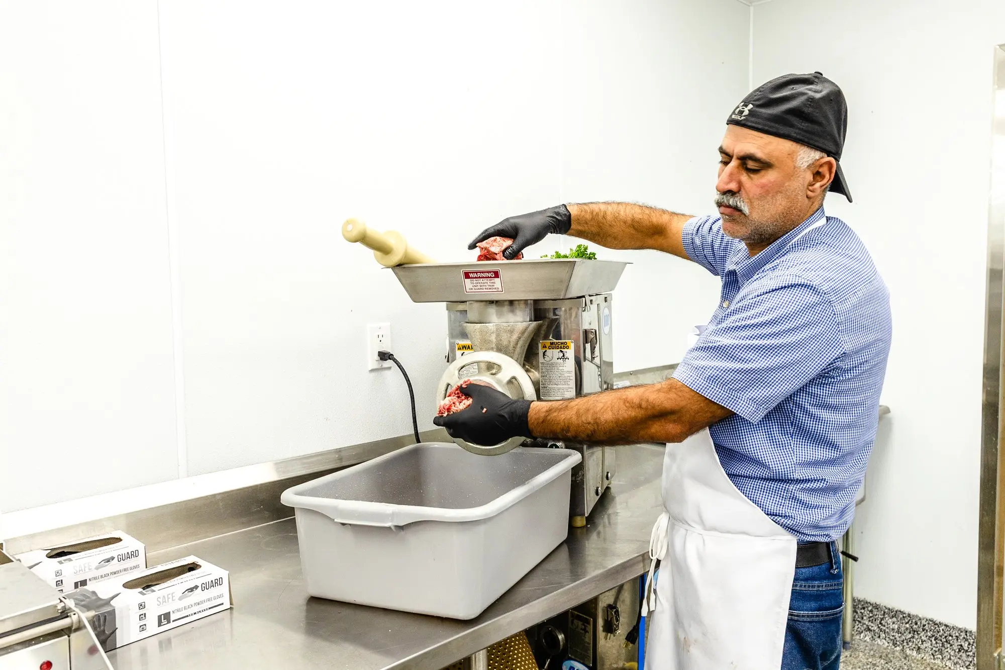 Our butcher grinding fresh beef.