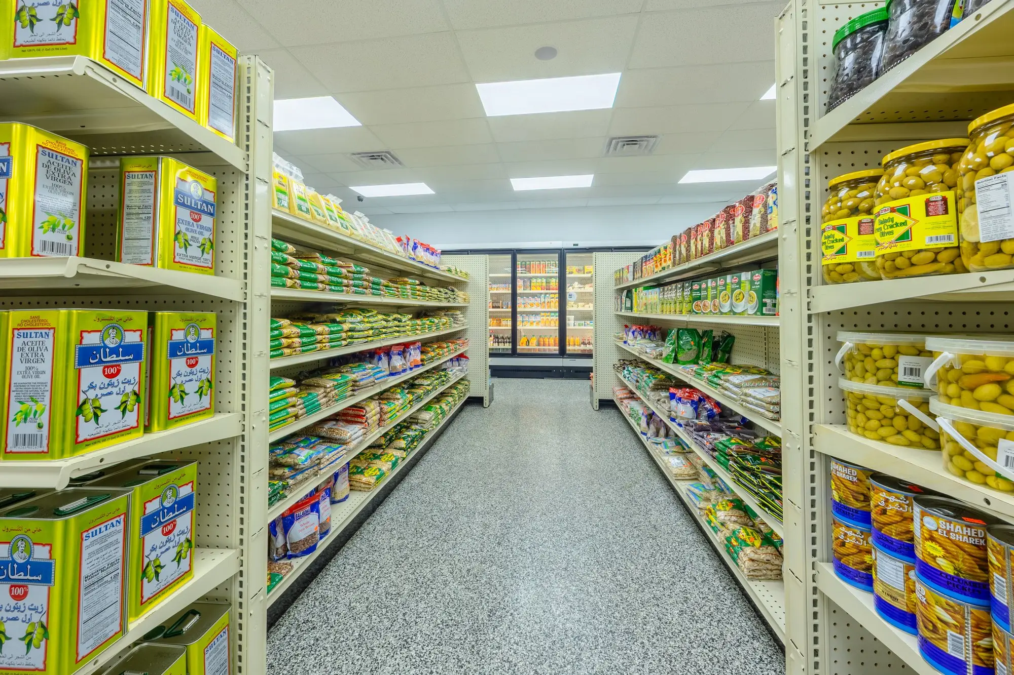 A Middle Eastern grocery aisle at ZAMZAM with oils and pantry staples.
