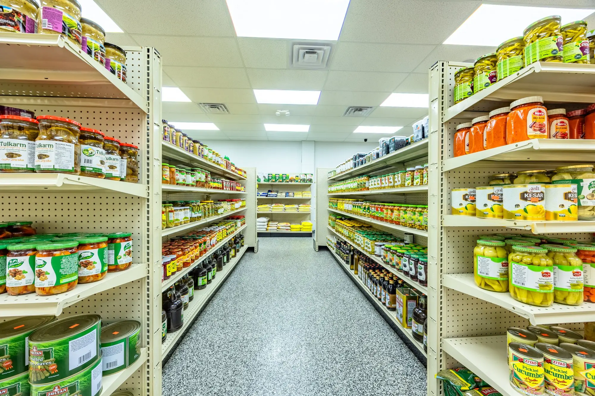 Shelves of olive and pickle jars in the pantry aisle at ZAMZAM.