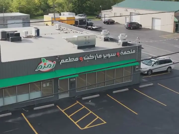 The ZAMZAM storefront on South 13th Street from above, with its green awning and parking lot.